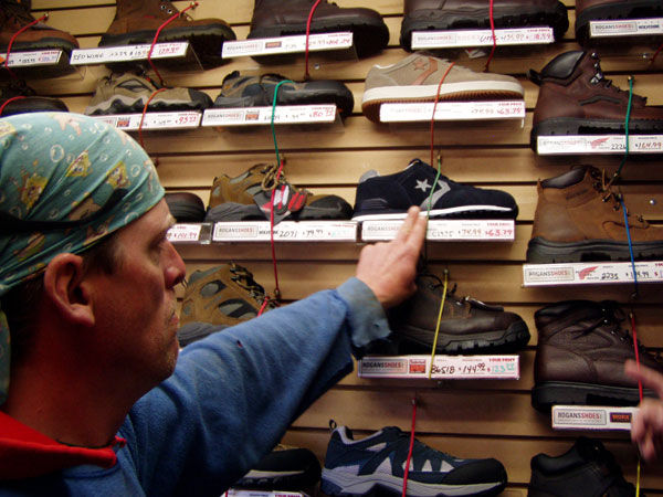 Customer Looking at a work shoe as a potential selection on the Work Truck